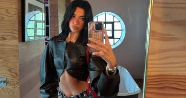 Dua Lipa flaunts her washboard abs in a cropped black leather jacket