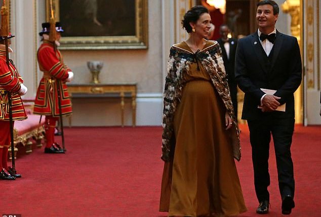 New Zealand Prime Minister Jacinda Ardern walks through Buckingham Palace with her husband Clarke Gayford on April 19, 2018. She was seven months pregnant at the time