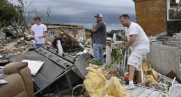 Volunteers help clean up debris from storm damage in the Sunshine Hills neighborhood in London, Ky., Monday, May 19, 2025