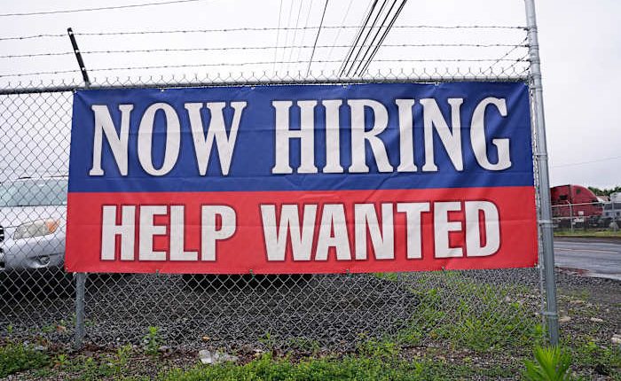 Fewer Americans sought unemployment benefits last week as layoffs remain low