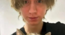 Photo of a young person holding a cat.