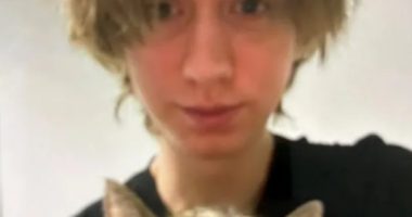 Photo of a young person holding a cat.