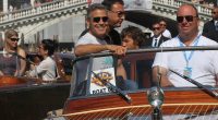 George Clooney, old friend Sandra Bullock and her son Louis cruise through Venice's canals ahead of film festival