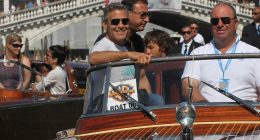 George Clooney, old friend Sandra Bullock and her son Louis cruise through Venice's canals ahead of film festival