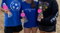 Three girls holding birthday treats, one wearing a Lady Hornet Soccer sweatshirt.