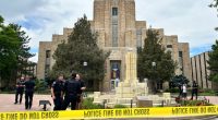 Police officers investigating a scene in front of a courthouse.