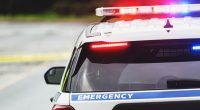 Rear view of a police car at an emergency scene.