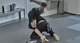 Jiu-jitsu students grappling on a mat.