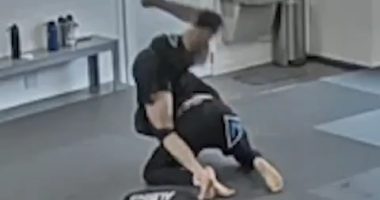 Jiu-jitsu students grappling on a mat.