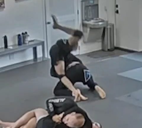 Jiu-jitsu students grappling on a mat.