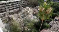 Rescue workers at the site of a missile strike in Tel Aviv.