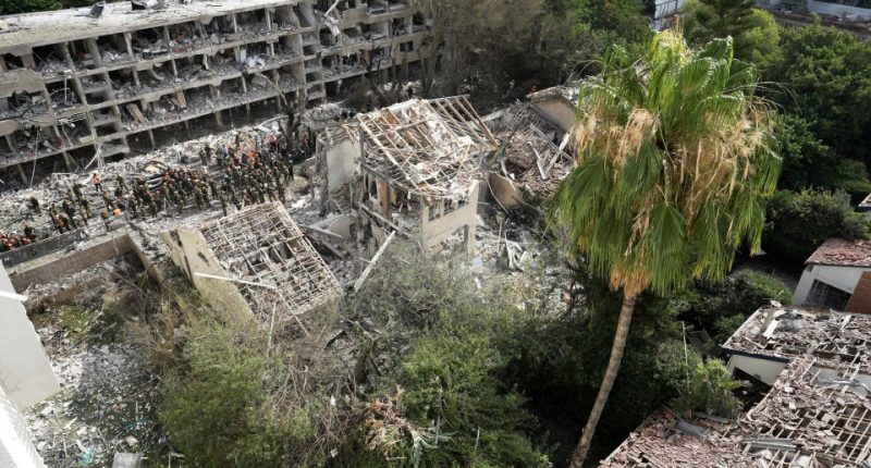 Rescue workers at the site of a missile strike in Tel Aviv.