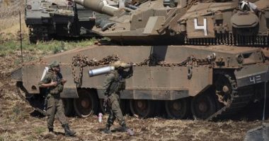 An Israeli soldier carries a shell next to a tank in northern Israel on Friday, September 27.