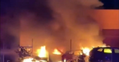 Hunt for suspected arsonist after car yard goes up in flames