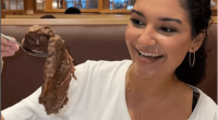 Woman holding a large spoonful of roast beef at Shady Maple Smorgasbord in Pennsylvania.