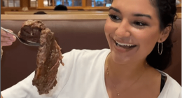Woman holding a large spoonful of roast beef at Shady Maple Smorgasbord in Pennsylvania.