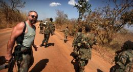 PIC BY KEVIN EVANS / CATERS NEWS - (PICTURED Machine Gun Preacher Sam Childers, South Sudan) - Meet the real-life Machine Gun Preacher, the incredible gun-totting reformed drug and alcohol abusing biker who went on to rescue orphans from blood-thirsty rebels who skin people ALIVE. Sam Childers might look like the archetypal handlebar-moustached Hells Angels type and thats because he was until he made a decision that changed his life. That life - which saw him leave his native USA and travel thousands of miles to East Africa - is now the subject Hollywood blockbuster Machine Gun Preacher released in the UK tomorrow (WEDS). Hunky heart-throb Gerard Butler plays Sam in the film which documents his real-life battle to rescue hundreds of children kidnapped in Africa. SEE CATERS COPY