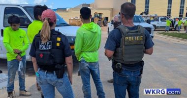 Three detainees wearing neon green shirts in Baldwin County, Alabama