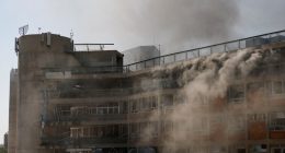 Smoke billows from Soroka Medical Center after a missile strike.