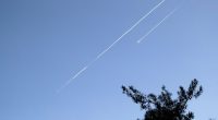 Two Iranian ballistic missiles in the sky.