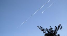 Two Iranian ballistic missiles in the sky.