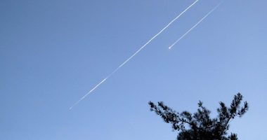Two Iranian ballistic missiles in the sky.