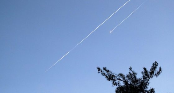 Two Iranian ballistic missiles in the sky.
