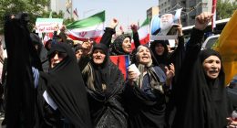 Thousands of Iranians waving flags and protesting.