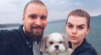 Photo of Artyom Timofeev and his wife with their dog.
