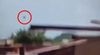 Video still showing an object falling from the sky.