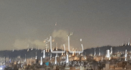 Nighttime view of a city with fireworks.