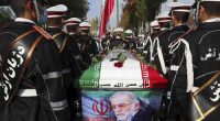 Military personnel stand near the flag-draped coffin of Mohsen Fakhrizadeh during his funeral in Tehran, Iran, in November 2020.