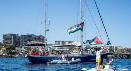CATANIA, ITALY - JUNE 01: Just before the departure of the Madleen, the Freedom Flotilla vessel, a young man raises the Palestinian flag from a pedal boat as other boats fly the same flag off the port of San Giovanni Li Cuti on June 01, 2025 in Catania, Italy. Swedish activist Greta Thunberg is among those who will attempt to sail to Gaza on a boat organized by the Freedom Flotilla Coalition (FFC), in a bid to break Israel's blockade of the Palestinian territory. Freedom Flotilla had to abort a previous journey in early May after it said its boat came under attack by drones in international waters near Malta. (Photo by Fabrizio Villa/Getty Images)