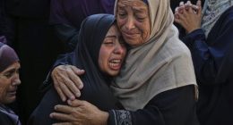 Relatives of Palestinians killed in Israeli strikes on the Gaza Strip mourn their deaths at Al-Shifa Hospital in Gaza City, Saturday, June 28, 2025. (AP Photo/Jehad Alshrafi)