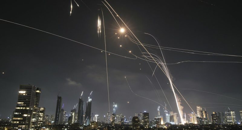 Israelis take cover in bomb shelters as Iran launches wave of missiles