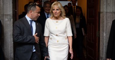 First Lady Jill Biden speaking with an advisor before a speech.