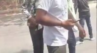 Video still of a man walking away from a crash.