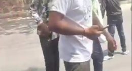 Video still of a man walking away from a crash.
