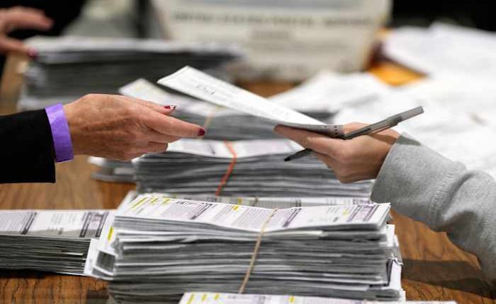 Justice Department's early moves on voting and elections signal a shift from its traditional role