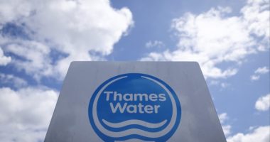 A Thames Water sign against a blue sky with white clouds