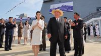 Kim Jong Un and his daughter attending the launch ceremony of a North Korean destroyer.