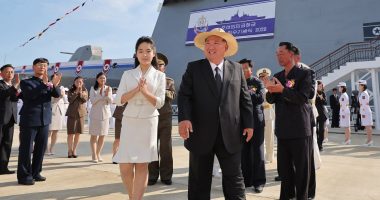 Kim Jong Un and his daughter attending the launch ceremony of a North Korean destroyer.