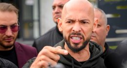 Andrew Tate speaking to the media outside a police station.