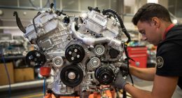 An employee works on a sports car engine at Lotus’s Hethel plant in Norfolk