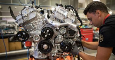 An employee works on a sports car engine at Lotus’s Hethel plant in Norfolk