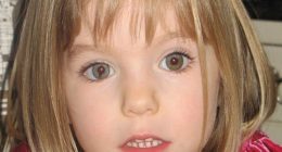 Portrait of a young girl with blonde hair and a pink dress.