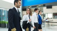 Plane crew walking through an airport terminal.