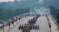 Military parade features helicopter flyover as police in LA disperse protest