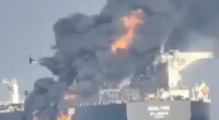 A burning oil tanker, the ABAL TIER, at sea.