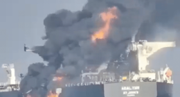 A burning oil tanker, the ABAL TIER, at sea.